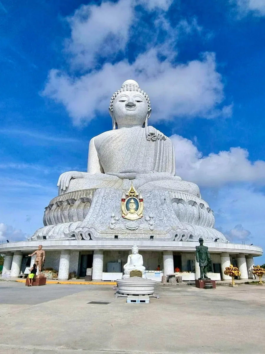The Big Buddha of Phuket atop Nakkerd Hill under a bright blue sky