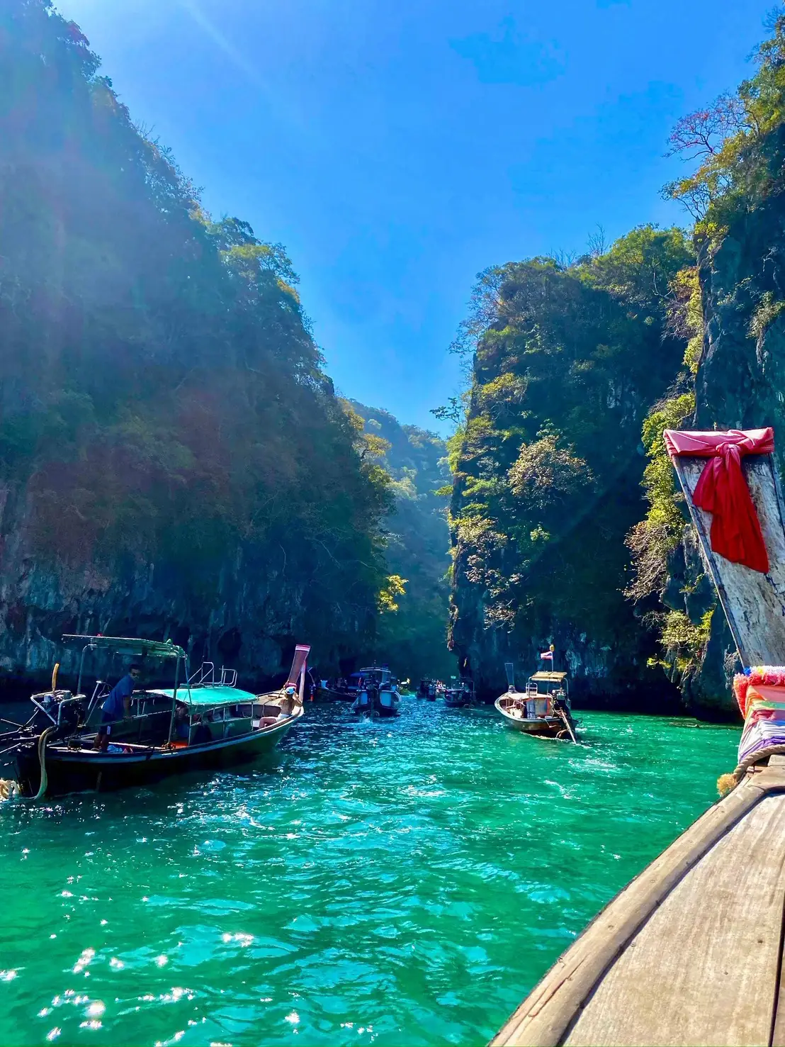Emerald-green lagoon flanked by limestone cliffs