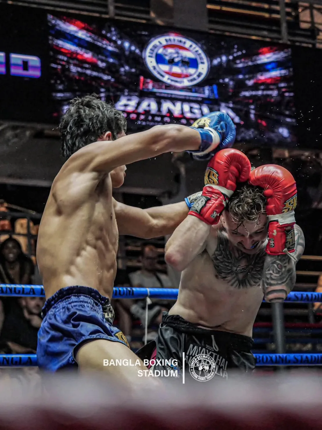 Muay Thai fighters trading punches in the ring at Bangla Boxing Stadium, Patong
