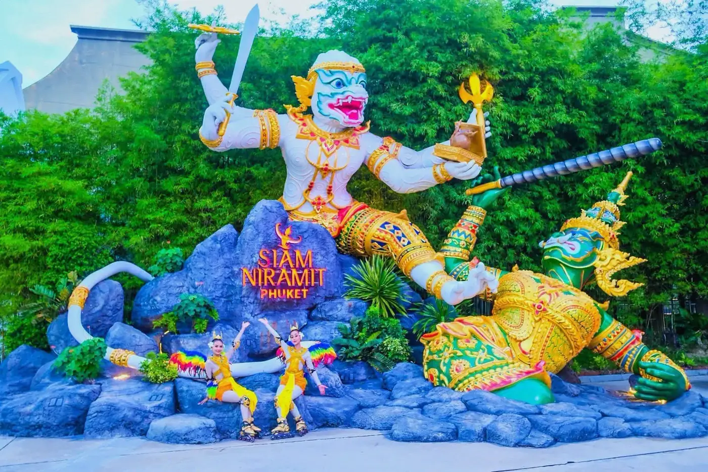 Hanuman sculpture at the Siam Niramit Phuket theatre entrance with Thai performers